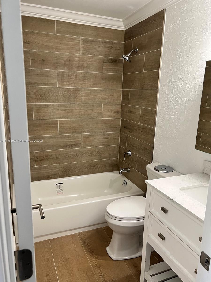11156 Goss Lane Boca Raton, FL 33428 - Photo 13 of 20 a bathroom with a toilet a sink and bathtub