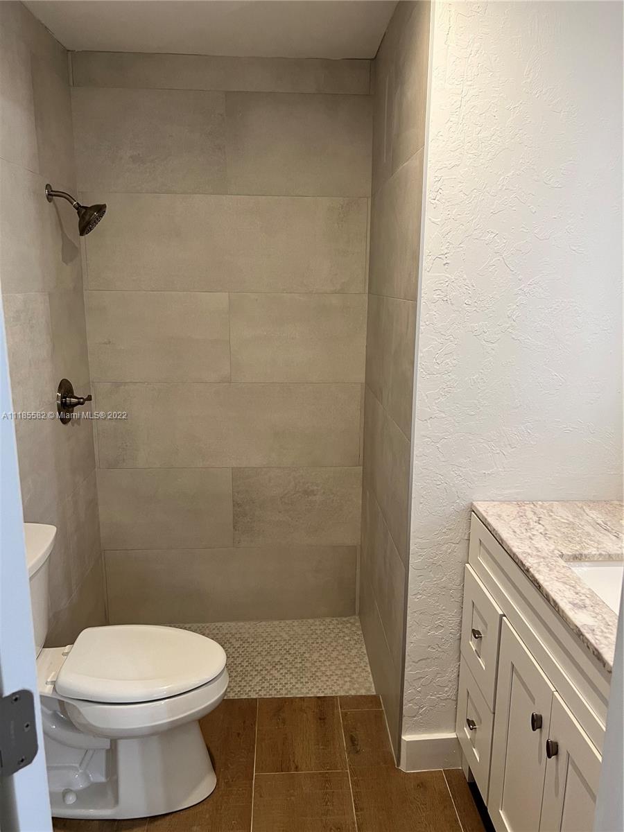 11156 Goss Lane Boca Raton, FL 33428 - Photo 15 of 20 a bathroom with a granite countertop toilet and a sink