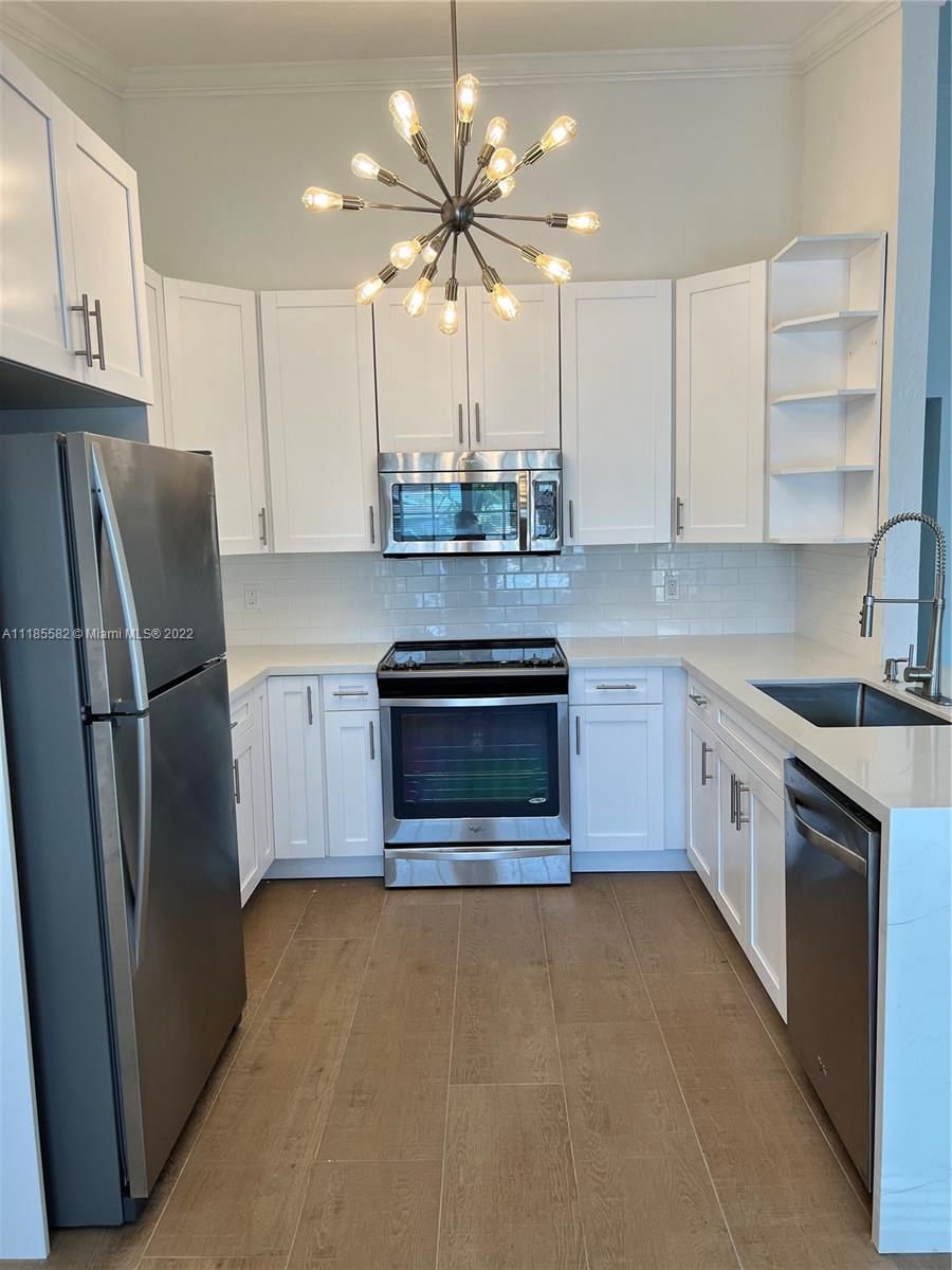 11156 Goss Lane Boca Raton, FL 33428 - Photo 6 of 20 a kitchen with stainless steel appliances granite countertop a stove a refrigerator and a sink