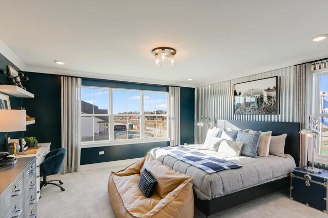 a bedroom with a bed and a large window