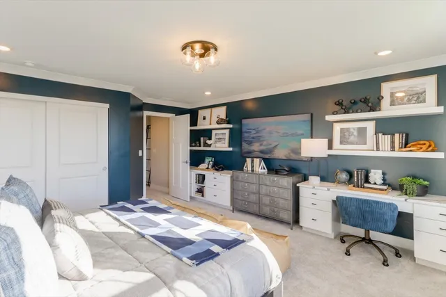 a bedroom with a workspace