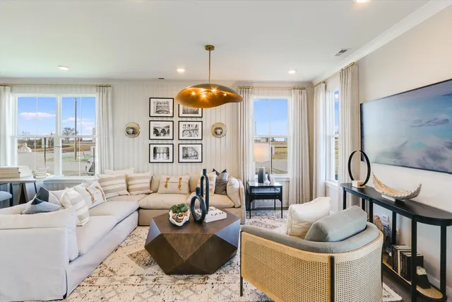 a living room with furniture and a chandelier