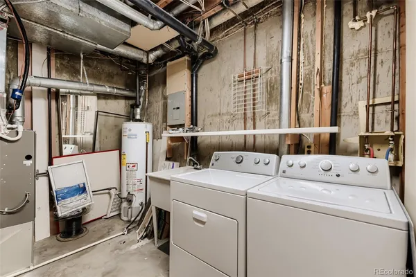 a view of a chair and table in the back yard of the house