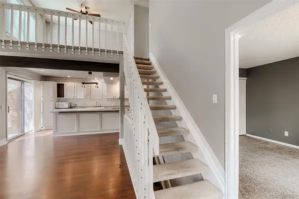 a view of an entryway with kitchen and hall