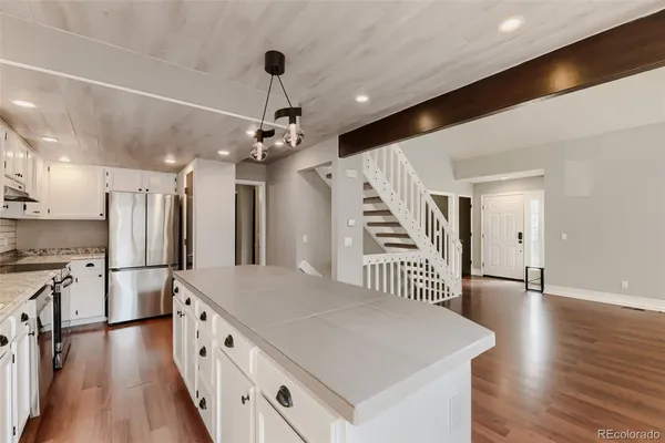 a kitchen with sink stove and refrigerator