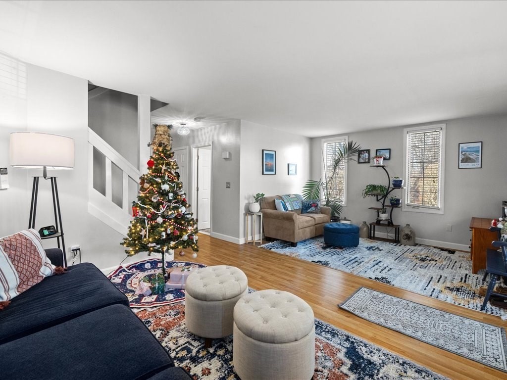 4 Strathmore Shire Drive, Unit B Uxbridge, MA 01569 - Photo 12 of 41 a living room with furniture and a chandelier