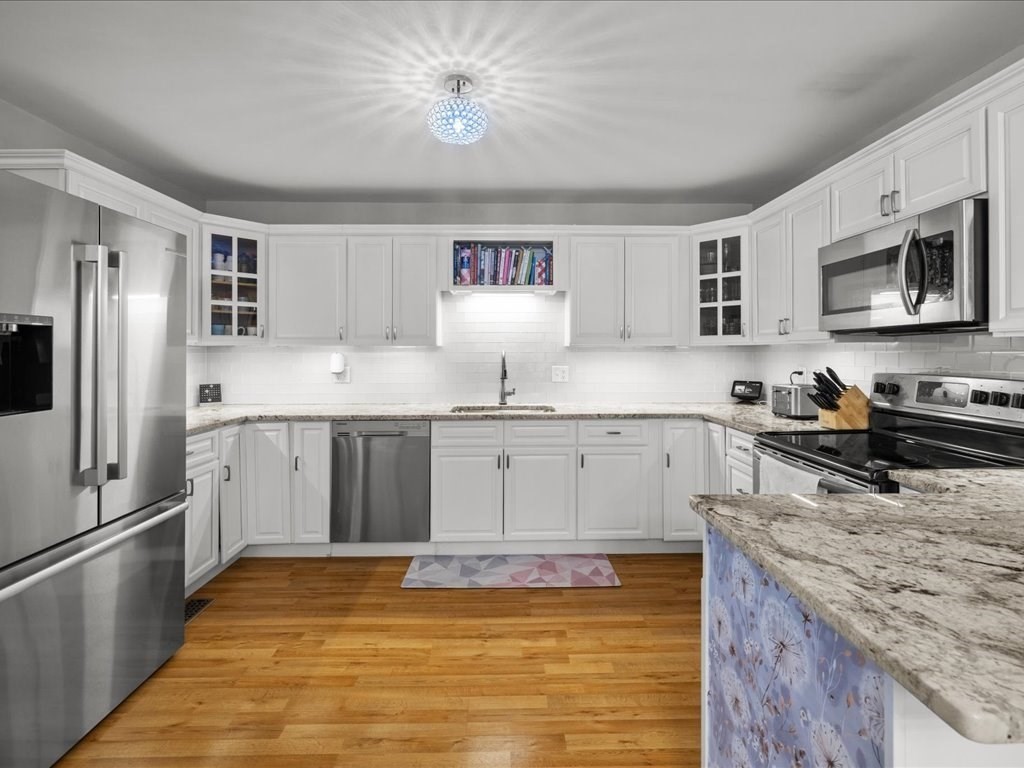 4 Strathmore Shire Drive, Unit B Uxbridge, MA 01569 - Photo 17 of 41 a kitchen with stainless steel appliances granite countertop a stove oven and a refrigerator
