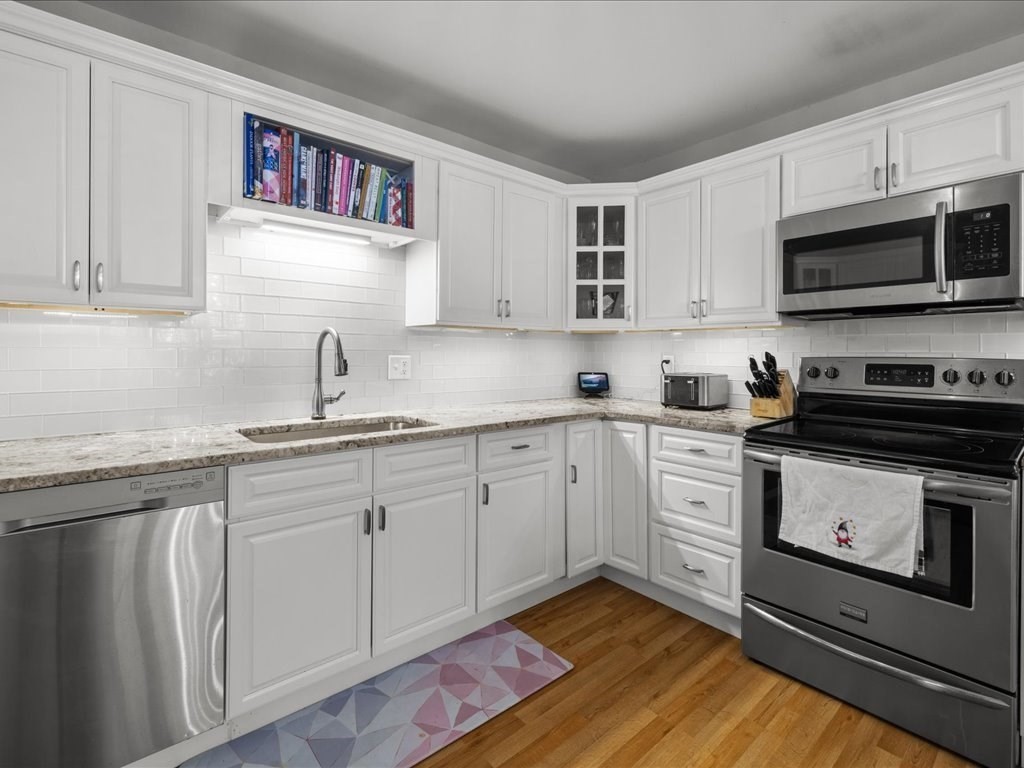 4 Strathmore Shire Drive, Unit B Uxbridge, MA 01569 - Photo 18 of 41 a kitchen with a sink cabinets and stainless steel appliances