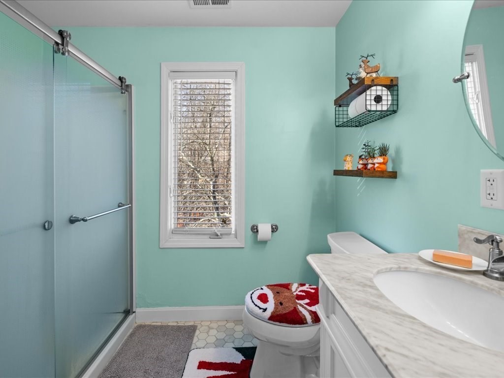 4 Strathmore Shire Drive, Unit B Uxbridge, MA 01569 - Photo 22 of 41 a bathroom with a sink mirror and toilet