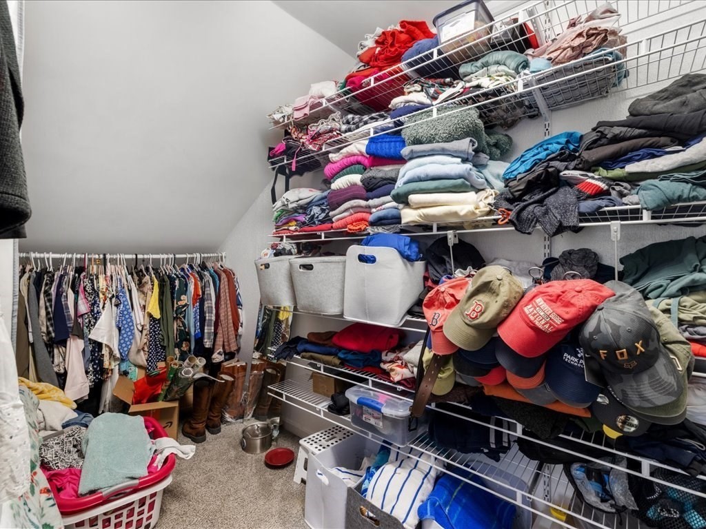 4 Strathmore Shire Drive, Unit B Uxbridge, MA 01569 - Photo 26 of 41 a store room with lots of different colored cloths