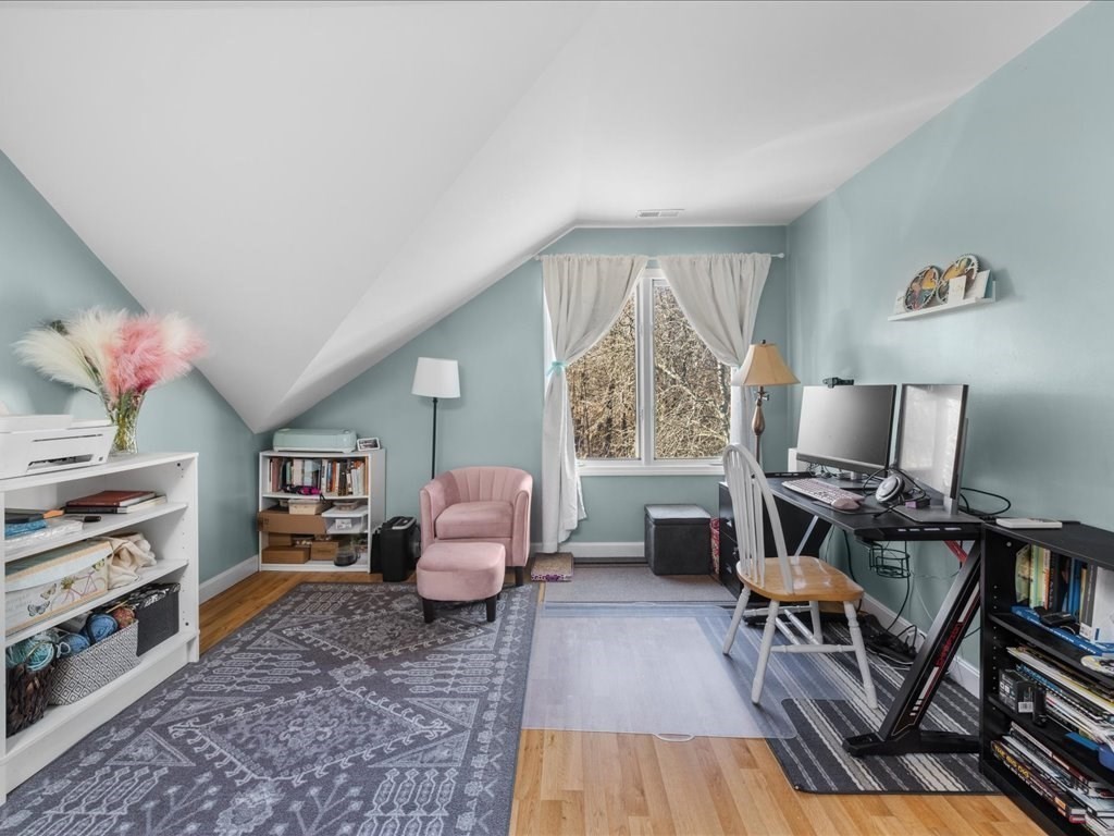 4 Strathmore Shire Drive, Unit B Uxbridge, MA 01569 - Photo 27 of 41 a living room with furniture and a wooden floor