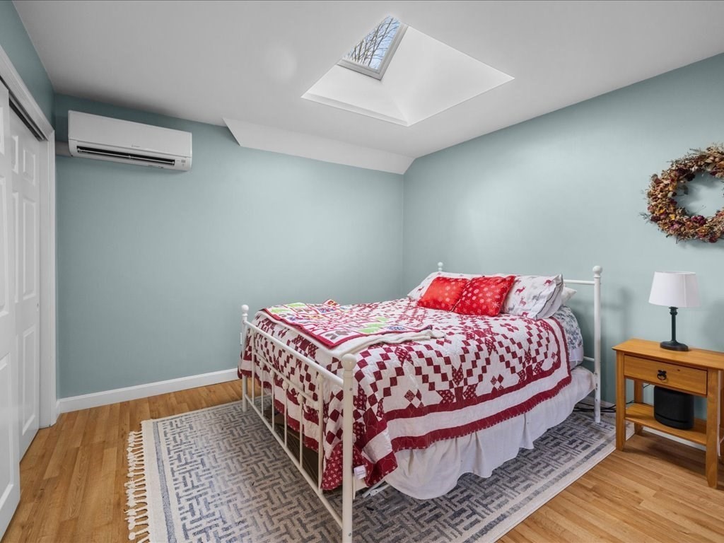 4 Strathmore Shire Drive, Unit B Uxbridge, MA 01569 - Photo 28 of 41 a bedroom with a bed and wooden floor