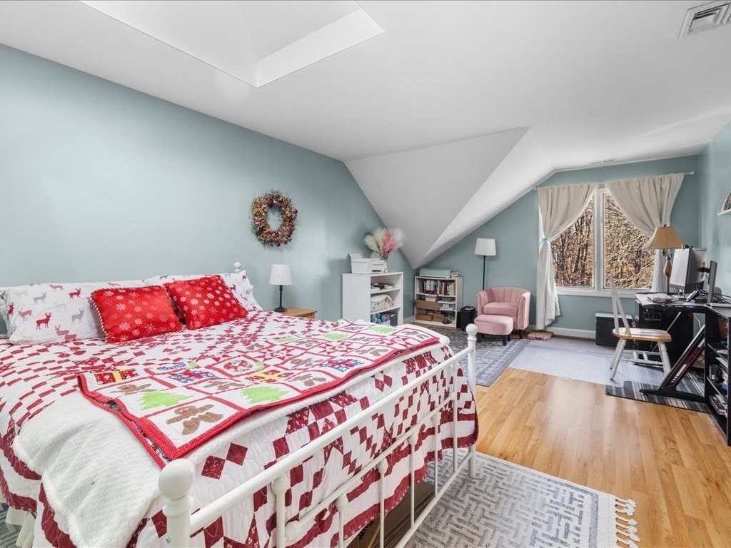 4 Strathmore Shire Drive, Unit B Uxbridge, MA 01569 - Photo 29 of 41 a bedroom with a bed a table and chair with the floor