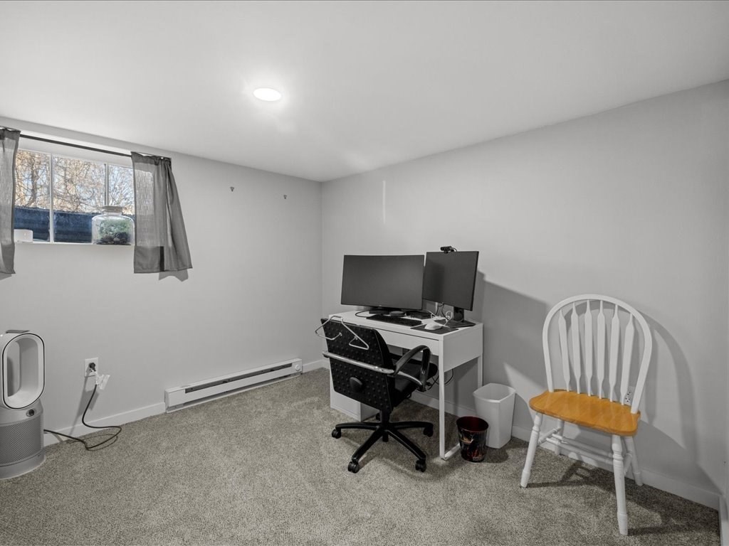 4 Strathmore Shire Drive, Unit B Uxbridge, MA 01569 - Photo 32 of 41 a view of a workspace with furniture and a window