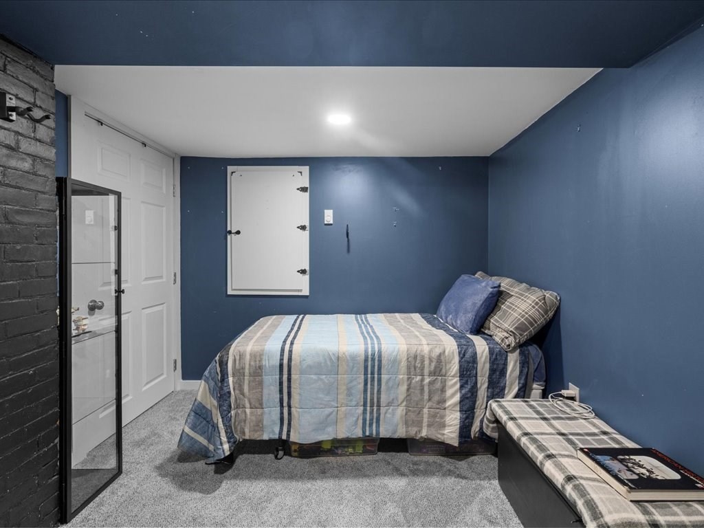 4 Strathmore Shire Drive, Unit B Uxbridge, MA 01569 - Photo 36 of 41 a bedroom with a bed and a chair