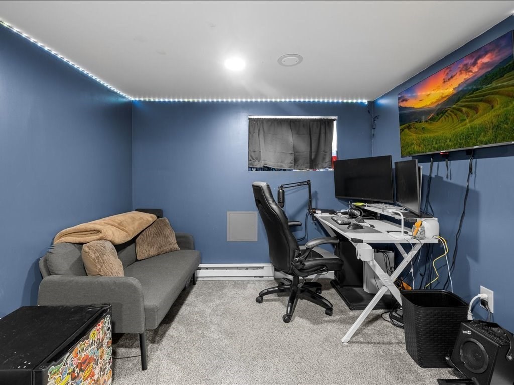 4 Strathmore Shire Drive, Unit B Uxbridge, MA 01569 - Photo 38 of 41 a workspace with furniture and a flat screen tv