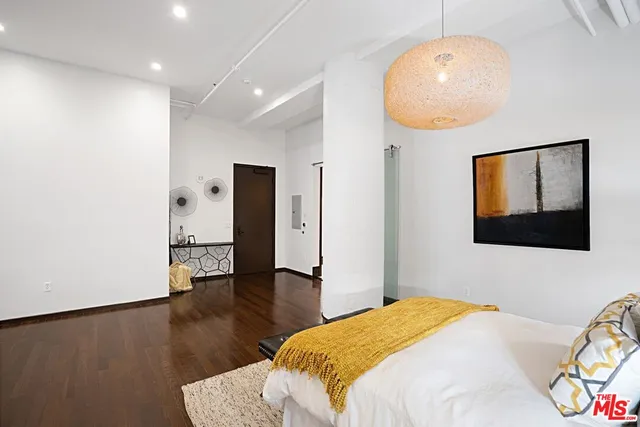 a bedroom with a bed and a chandelier