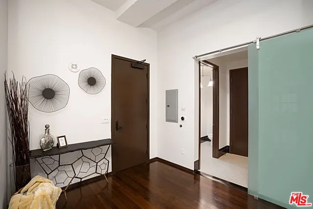a view of a hallway with wooden floor