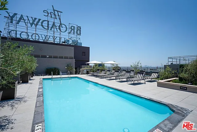 a view of a swimming pool with furniture