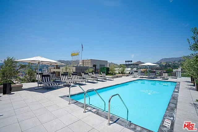 a view of a patio with a dining table and chairs with wooden floor
