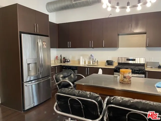 a kitchen with a refrigerator and a sink