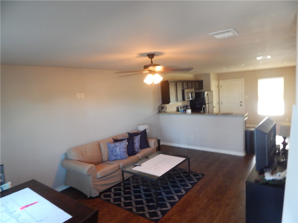 3500 South College Avenue, Unit 204 Bryan, TX 77801 - Photo 2 of 7 a living room with furniture and a chandelier
