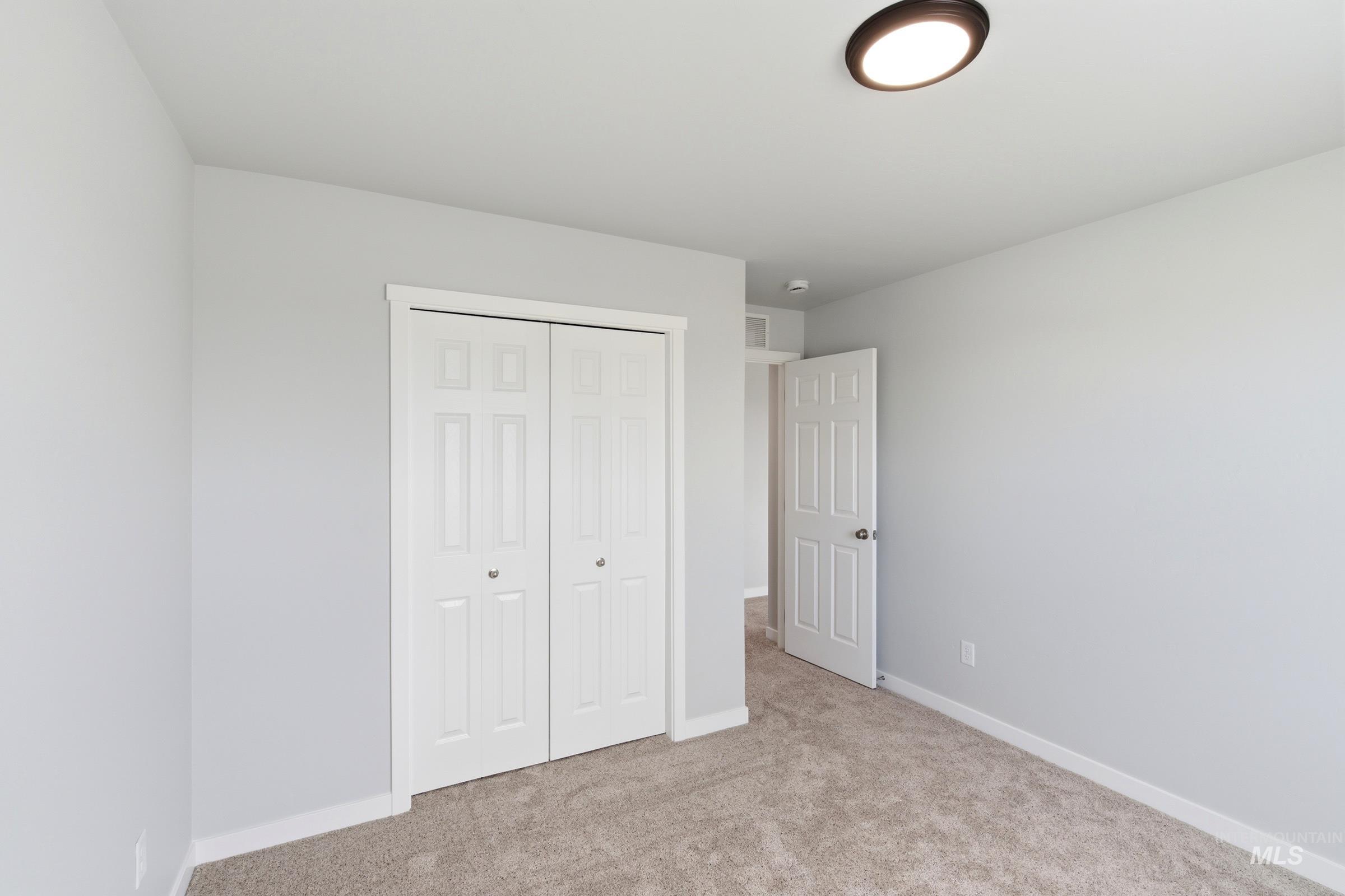 16558 Dunning Way Caldwell, ID 83607 - Photo 35 of 35 Bedroom featuring neutral carpeting, light gray wall paint, and white trim