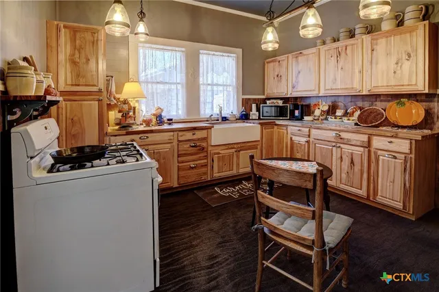 a kitchen with stainless steel appliances a stove a refrigerator and cabinets