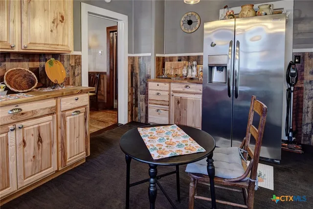 a kitchen with stainless steel appliances a stove a refrigerator and cabinets