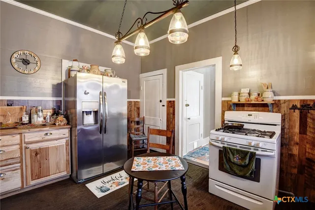 a kitchen with stainless steel appliances granite countertop a sink stove and cabinets