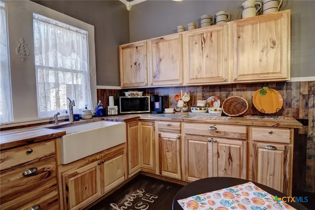 a kitchen with stainless steel appliances a sink stove and cabinets