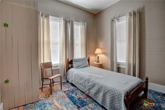 a bedroom with a bed and chair