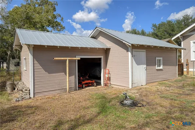 a view of a backyard with wooden fence