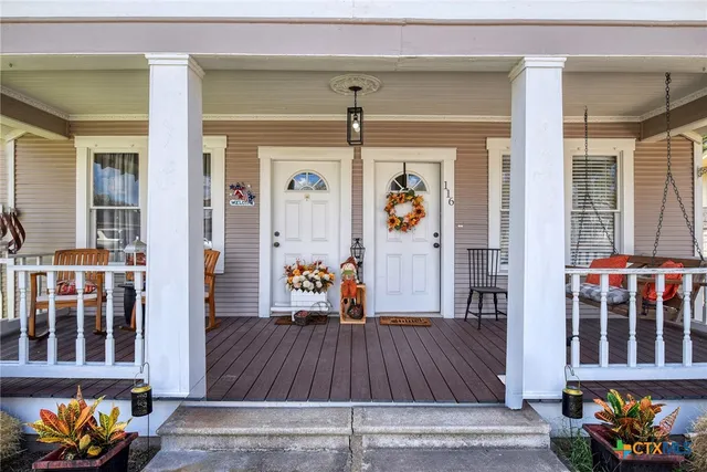 a living room filled with furniture and wooden floor