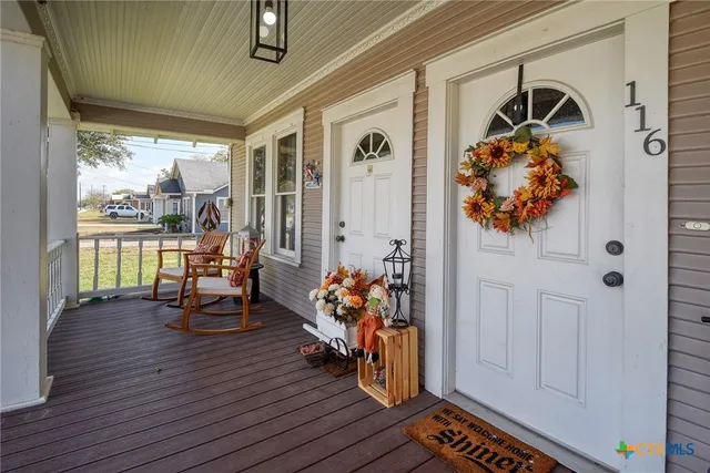a living room with furniture flat screen tv and wooden floor