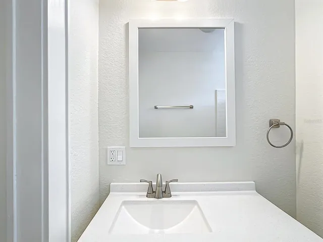a bathroom with a sink and mirror