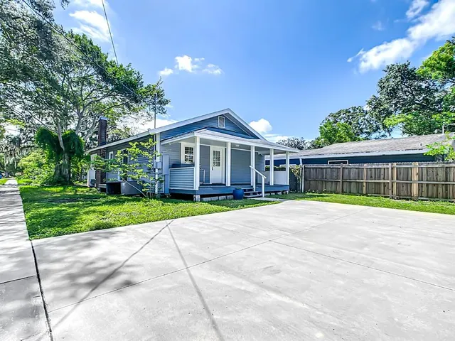 a view of house with outdoor space and swimming pool