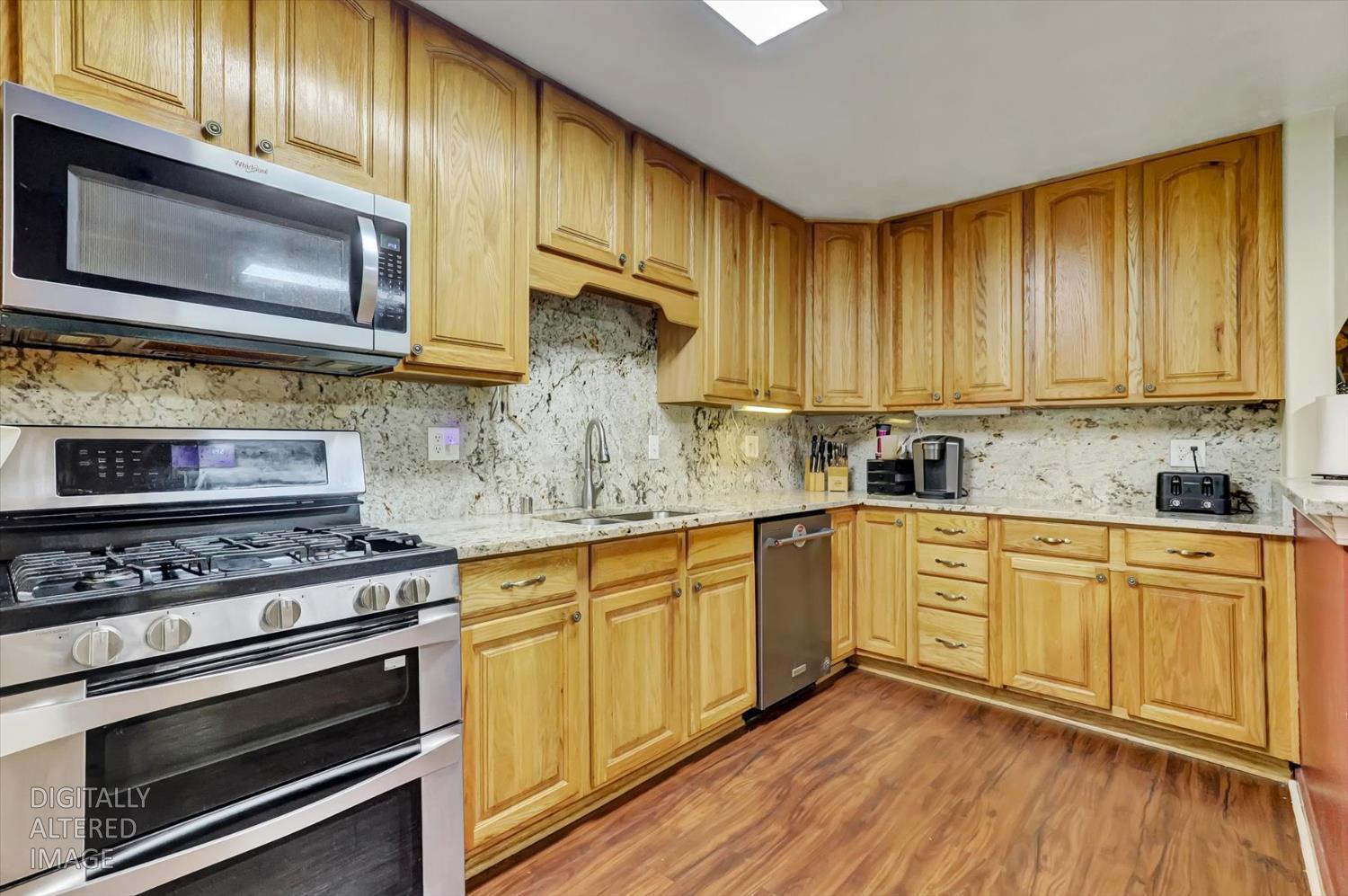 11312 Alpine Lane Grass Valley, CA 95945 - Photo 6 of 69 a kitchen with stainless steel appliances a stove a sink cabinets and a wooden floor