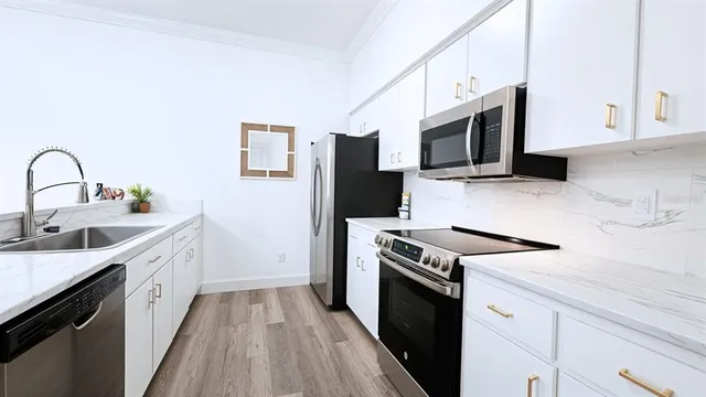 a bathroom with a granite countertop sink a toilet and shower
