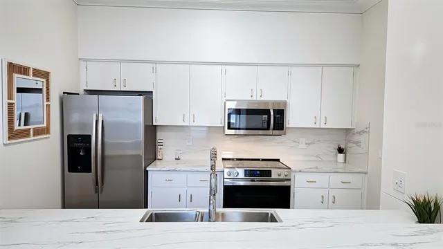 a bedroom with a large bed and a chandelier