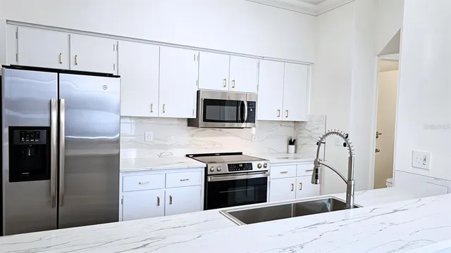 a bedroom with a large bed and a large window