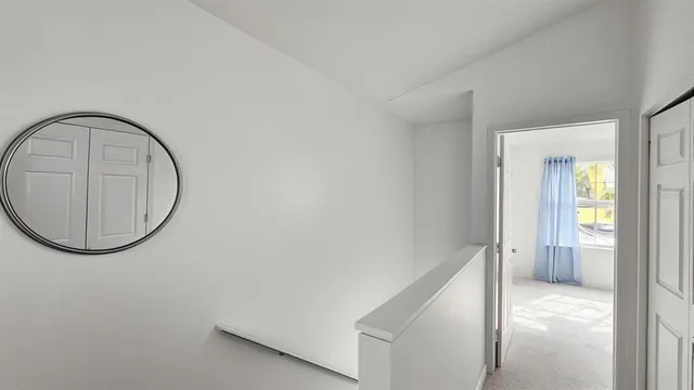 a view of a bedroom with a large window and doors