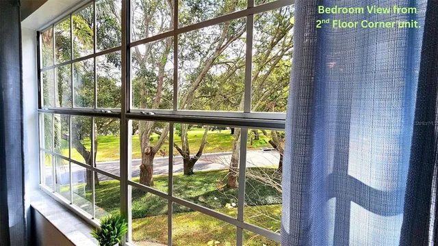 an aerial view of residential building with green space