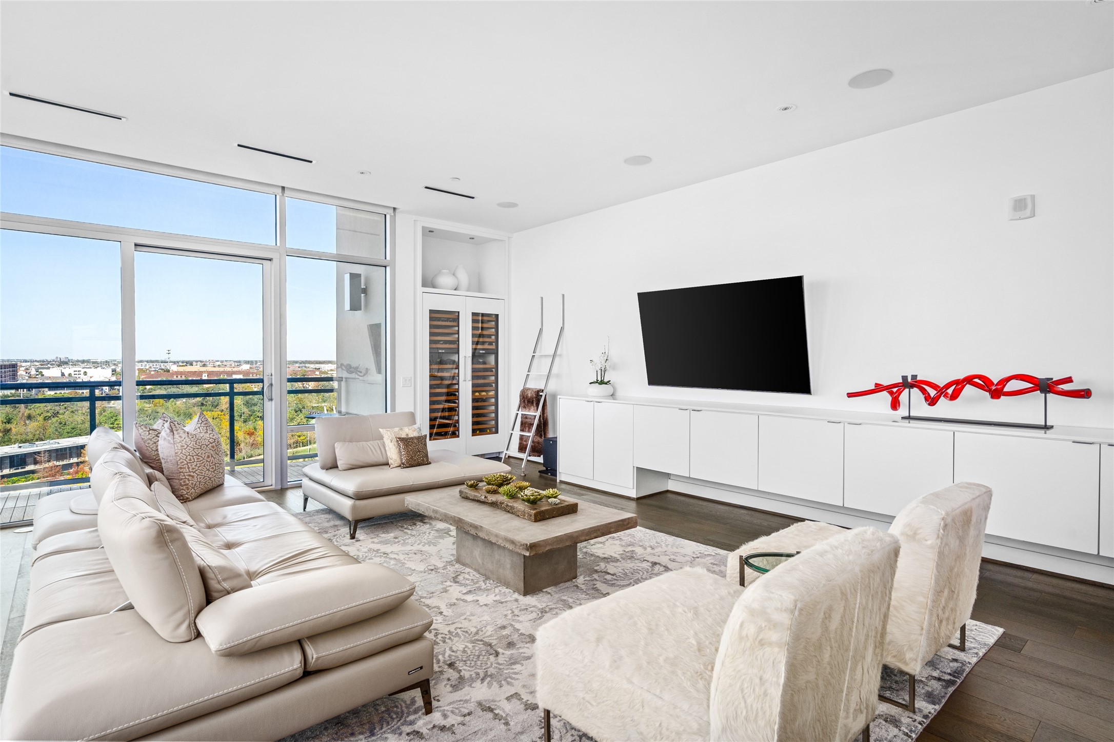 3331 D'Amico Street, Unit 904 Houston, TX 77019 - Photo 3 of 21 a living room with furniture flat screen tv and a floor to ceiling window