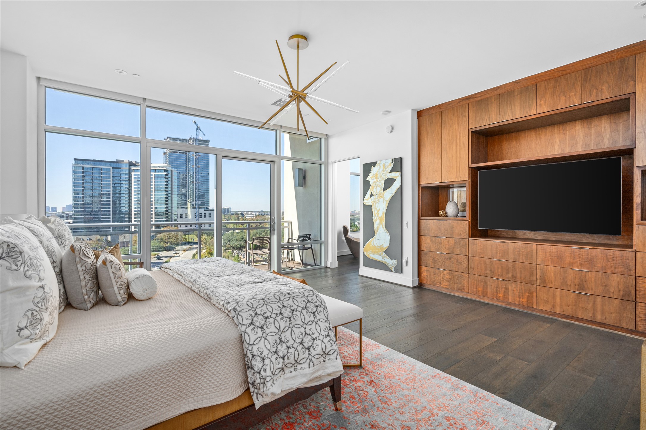 3331 D'Amico Street, Unit 904 Houston, TX 77019 - Photo 10 of 21 a spacious bedroom with a large bed and a flat screen tv