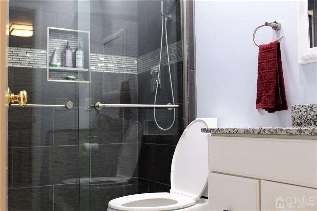 4602 Stonehedge Road, Unit 4602 Edison, NJ 08820 - Photo 13 of 25 a bathroom with a shower and toilet
