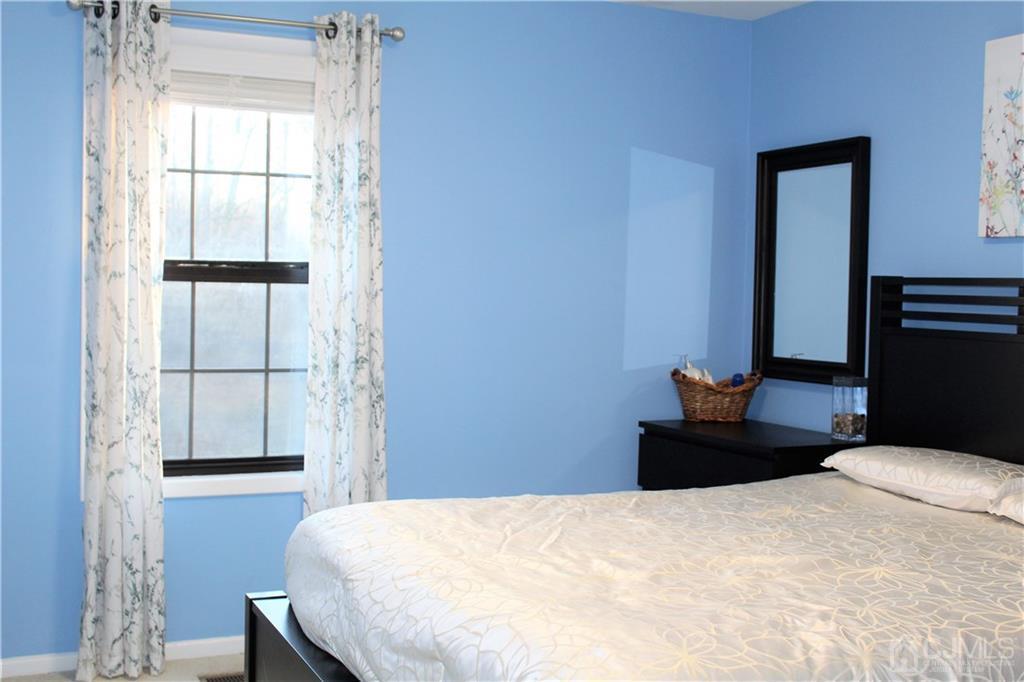 4602 Stonehedge Road, Unit 4602 Edison, NJ 08820 - Photo 14 of 25 a bedroom with a bed and a window