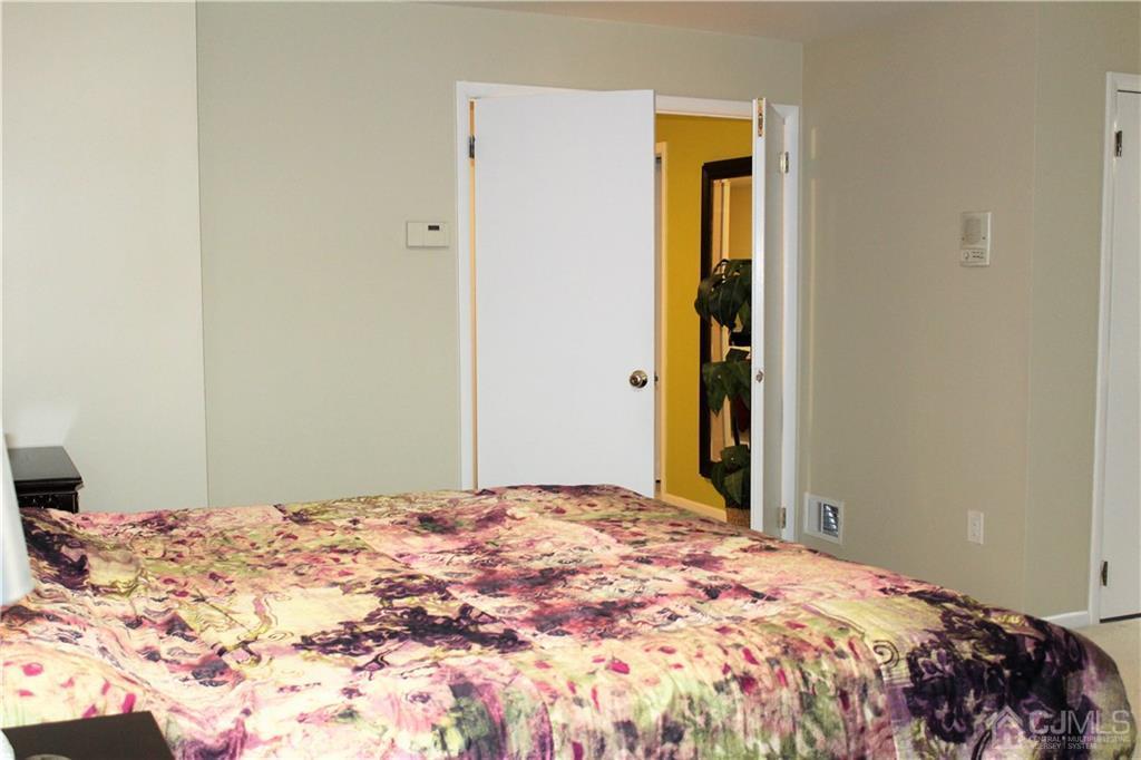 4602 Stonehedge Road, Unit 4602 Edison, NJ 08820 - Photo 16 of 25 a bedroom with a bed and a window