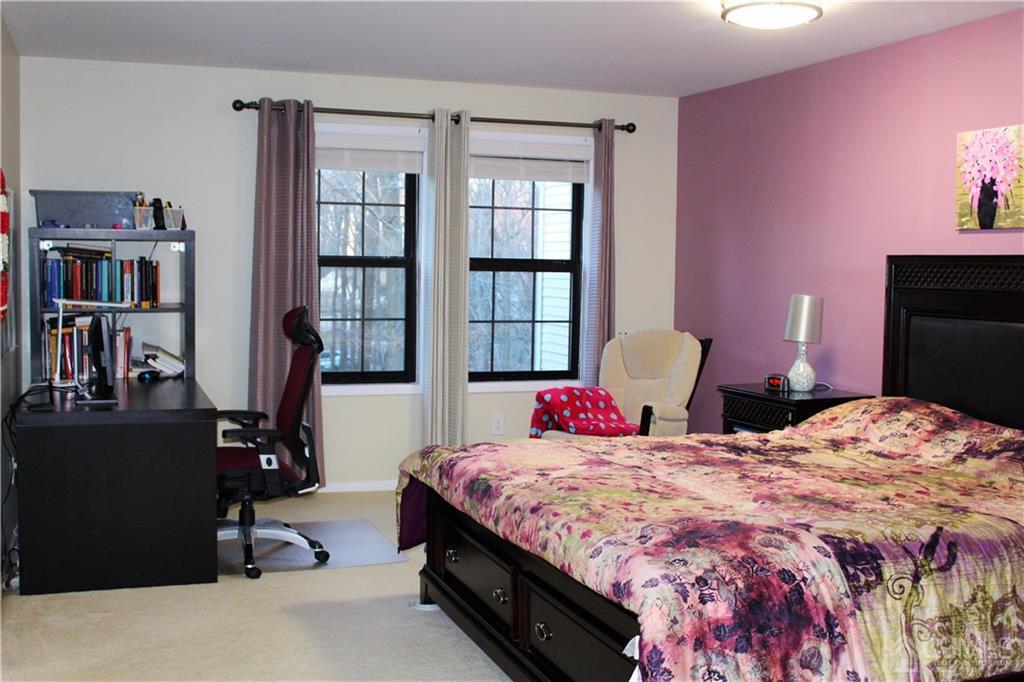 4602 Stonehedge Road, Unit 4602 Edison, NJ 08820 - Photo 19 of 25 a bedroom with bed and wooden floor