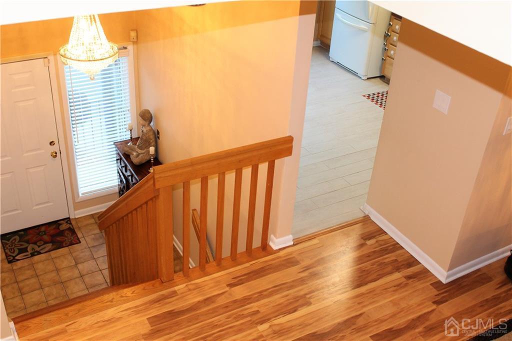 4602 Stonehedge Road, Unit 4602 Edison, NJ 08820 - Photo 2 of 25 a view of a balcony with wooden floor and staircase